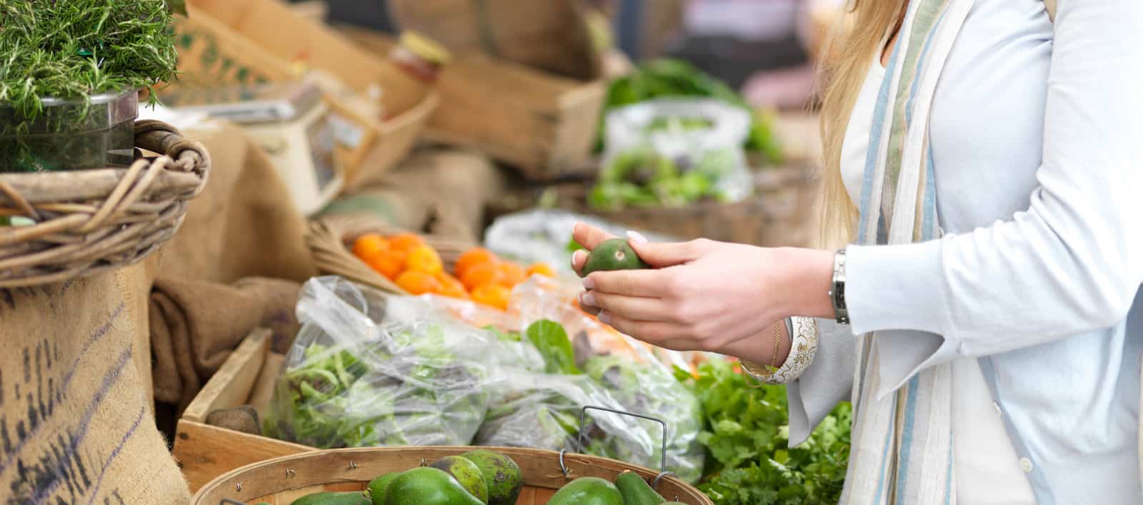 a new mover checks out vegetables at the local marketplace
